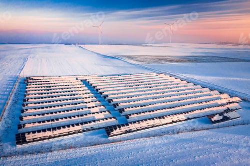 Preview: Alternative energy. Snowy solar panels and wind turbines in winter