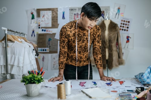 Preview: Portrait of Professional Asian young male tailor with measuring tape on neck.