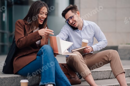 Preview: Students sharing a fun moment while studying outdoors on campus steps