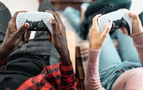 Preview: Top view of young multiracial teenagers playing online video game console at home