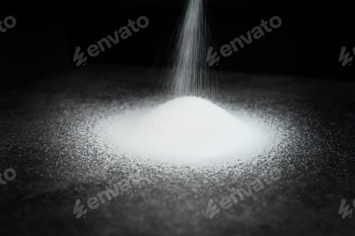 Preview: Detail of white sugar poured on black background
