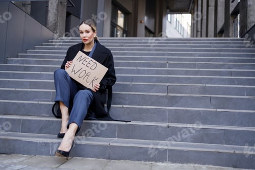 Preview: Unemployed woman holding need work sign