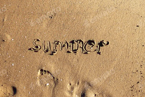 Preview: the word summer handwritten on the sandy beach and footprint copy space