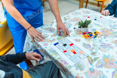 Preview: Nurse assisting elderly man playing bingo in nursing home