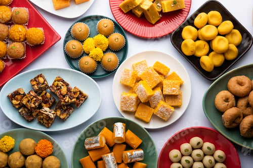Preview: Group of Indian assorted sweets or mithai with diya