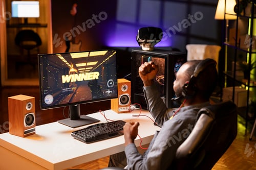 Preview: Gamer celebrating winning online multiplayer science fiction videogame