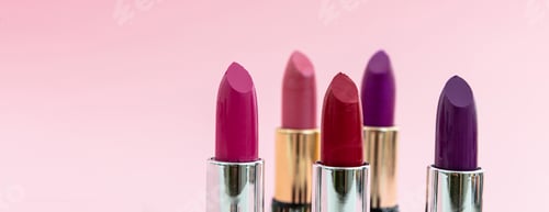 Preview: Lipsticks various colors against pink background, closeup view