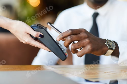 Preview: Black man using gadget for mobile payment