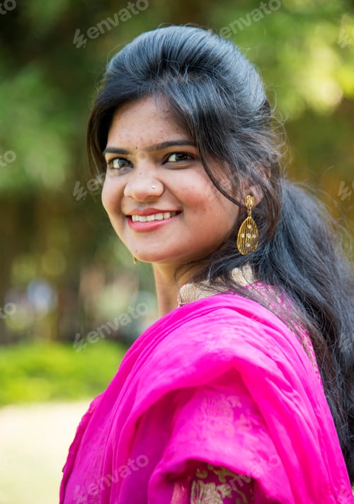 Preview: Outdoor portrait of beautiful young Indian girl in traditional dress.