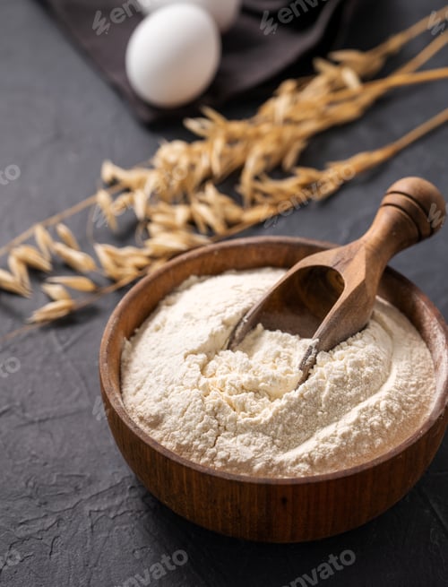 Preview: Organic baking ingredients. Oatmeal and eggs on a dark background close up.