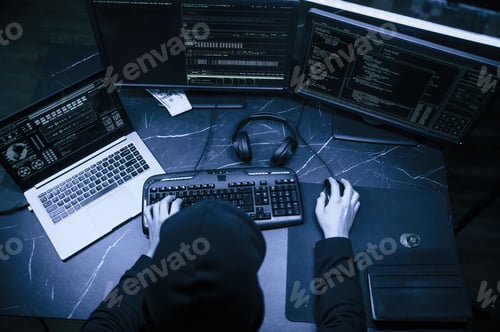 Preview: Male professional hacker is sitting by computer, conception of virus