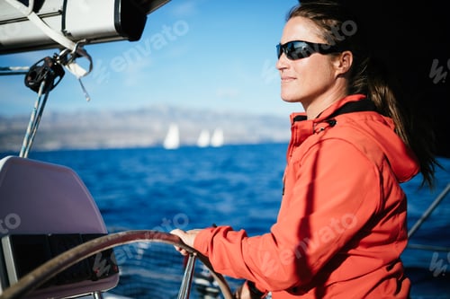 Preview: Attractive strong woman sailing with her boat