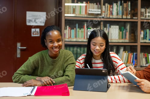 Preview: Diverse students studying together in library