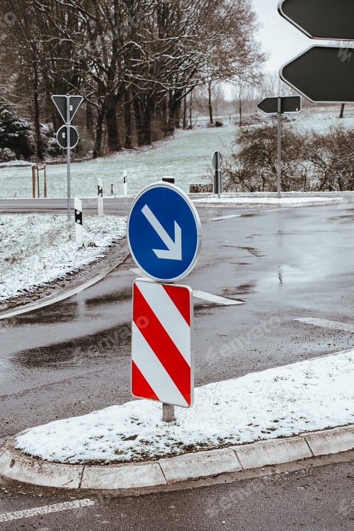 Preview: Vertical shot of a road split sign in the street in winter