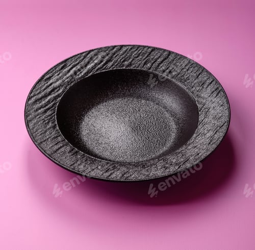 Preview: An empty round ceramic plate on a pink background as a kitchen utensil. An empty plate