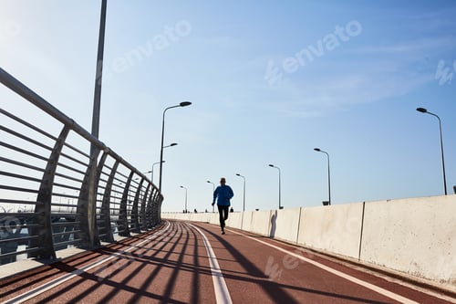 Athletic Person Runs on Track on a Sunny Day