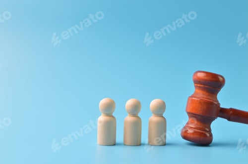 Preview: Wooden doll figure of peoples and judge gavel isolated on a blue background