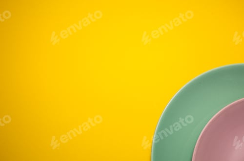 Preview: colorful plates composition on yellow background