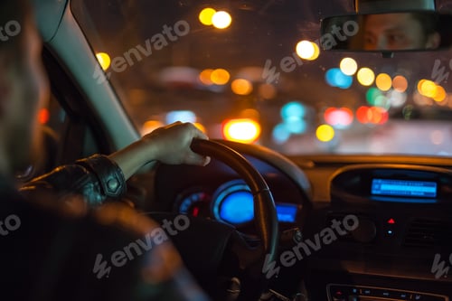 Preview: The man drive a modern car in the city. Evening night time