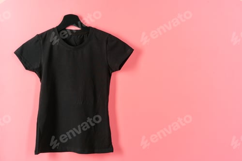 Preview: Black plain t-shirt hanging on a hanger