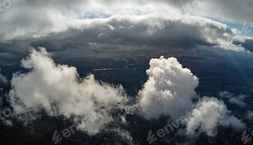 Preview: Aerial view from airplane window at high altitude of distant city