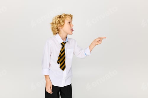 Preview: Blonde boy expressing emotion in school uniform with a striped tie in studio setting