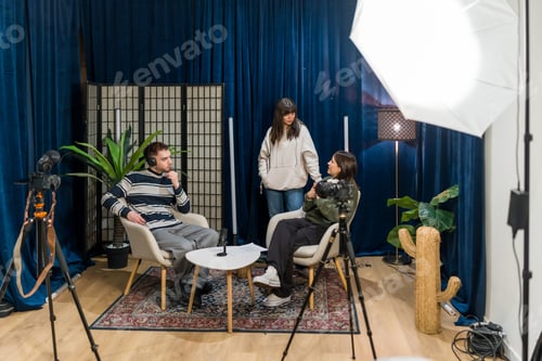 Preview: Young adults recording a podcast interview in media studio