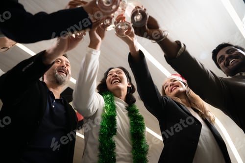 Preview: Group of friends toasting with champagne at New Year party in office