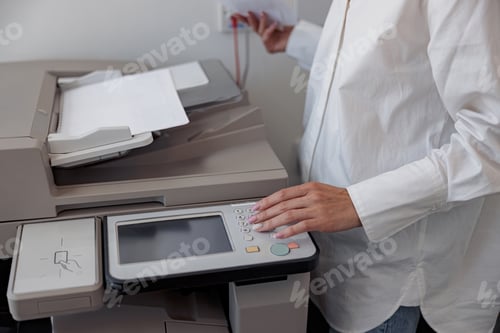 Preview: Close up of woman worker scanning a document on photocopy machine In modern office