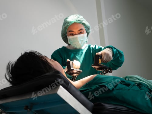 Preview: In hospital emergency room doctor shocking the heart use defibrillator to save patient life