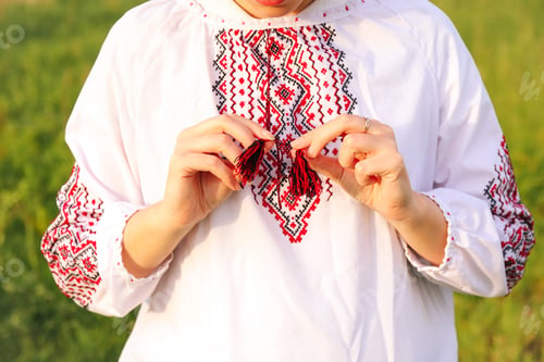 Preview: The close-up showcases a woman wearing a vyshyvanka, emphasizing the cultural significance of the em