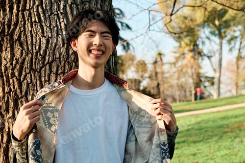 Preview: smiling young asian man showing white t-shirt for design