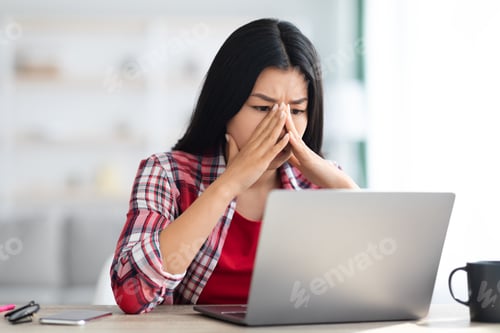 Preview: Stressed Asian Freelancer Woman Looking At Laptop Screen With Worry