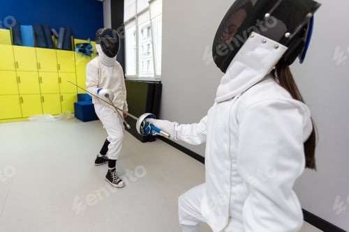 Preview: Fencer woman with fencing sword. Fencers duel concept.