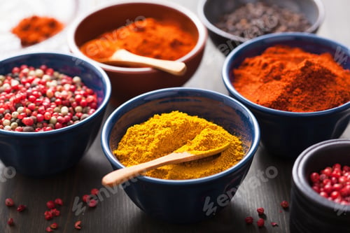 Preview: spices in bowls: curry, pink and black pepper, paprika powder