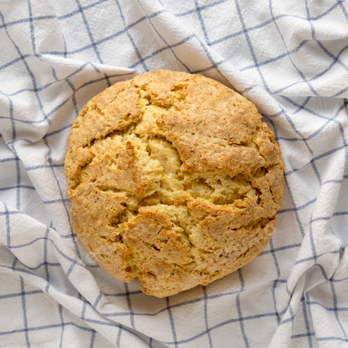 Preview: Homemade Irish Soda Bread on cloth, overhead view. Flat lay, top view, from above.