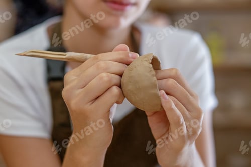 Preview: Close up of hands making bowls in a pottery workshop. Concept hobby and DIY