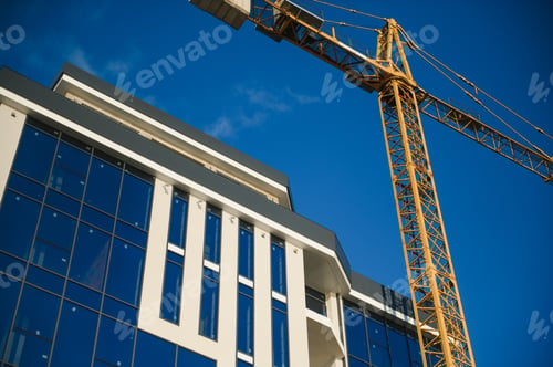 Preview: Construction cranes are standing near building houses