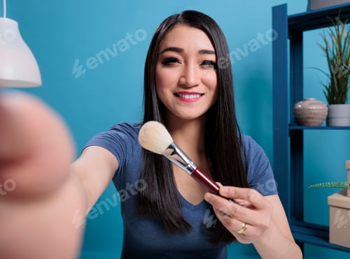 Preview: Pov of beauty influencer holding makeup brush showing to subscribers