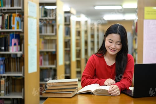 Preview: Young girl reading book in library