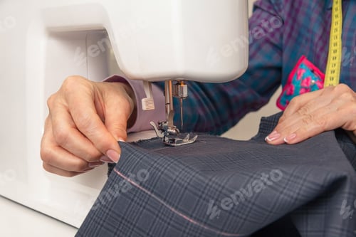 Preview: Seamstress hands working on a sewing machine