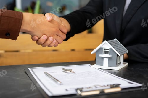 Preview: Real estate agents shaking hands To congratulate buyers after giving buyers a purchase contract, a c
