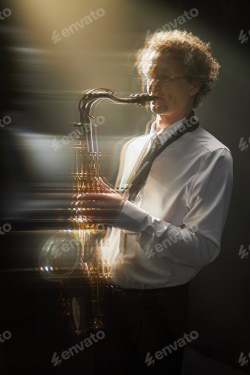 Preview: Adult Male Saxophone Player Improvising on Instrument under Spotlight in Studio