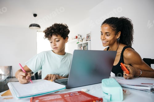 Preview: Girl doing her homework with mother