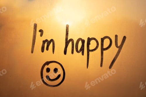 Preview: lettering text I am happy and smile painted on window flooded with raindrops on sunset window
