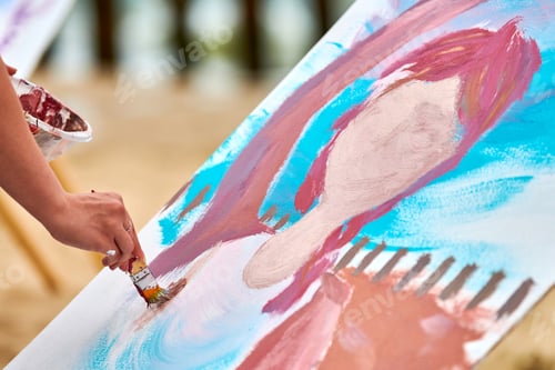 Preview: Amateur painter draws picture on white canvas at outdoor art exercise, painting performance