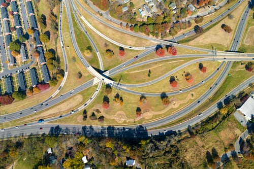 Preview: American freeway intersection with fast driving cars and trucks.
