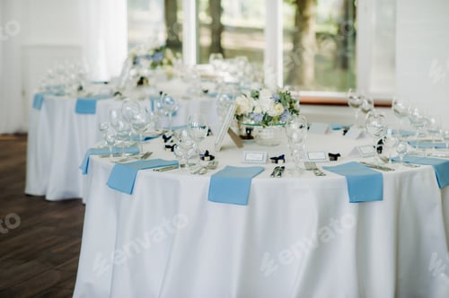 Preview: The festive table is decorated in light colors with blue napkins and flowers without food