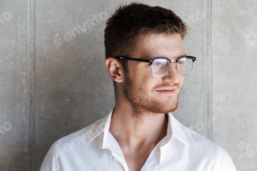Preview: Close up portrait of a smiling young man in eyeglsses