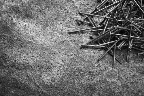 Preview: Many metal nails on grey background, flat lay. Space for text